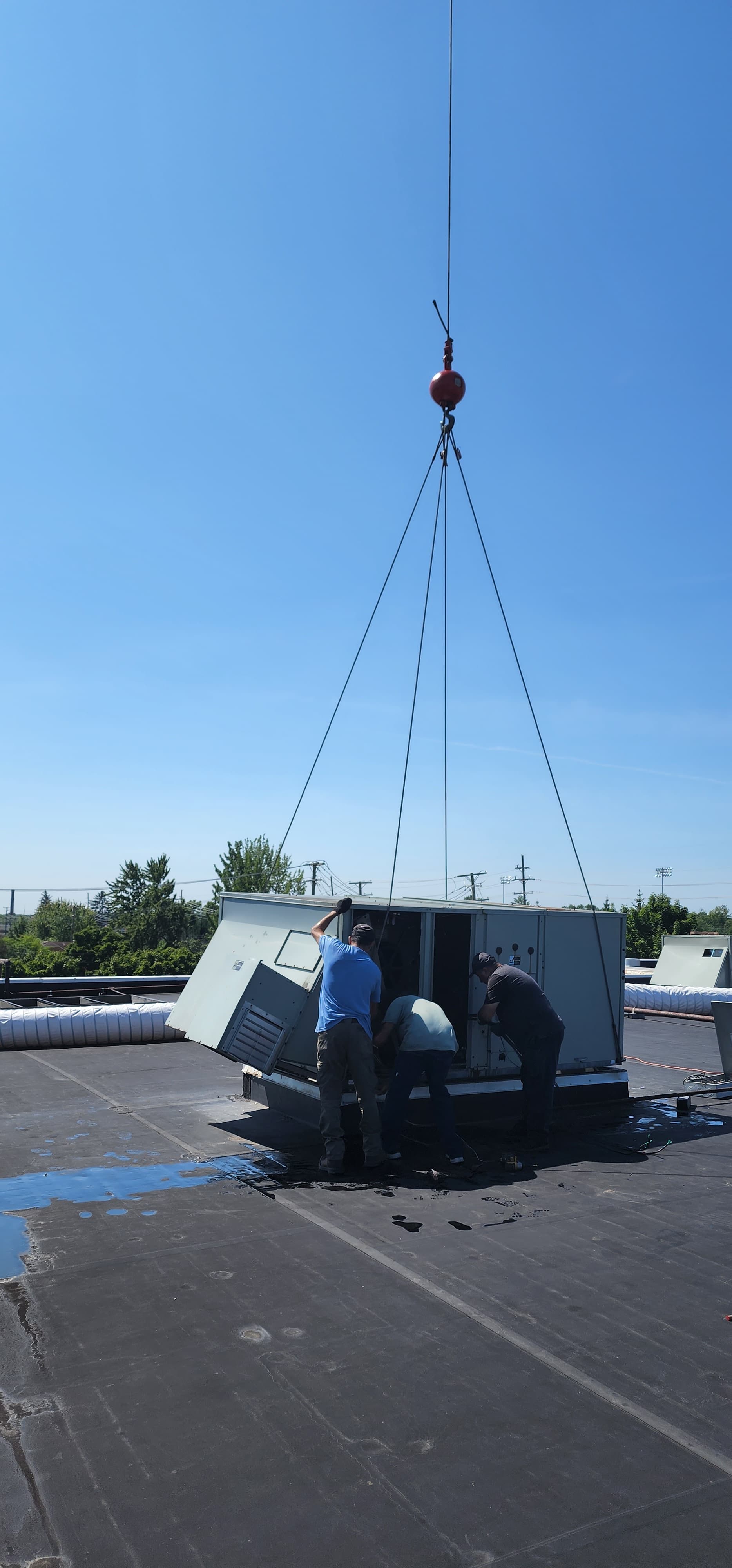 Newly installed rooftop HVAC unit after crane placement